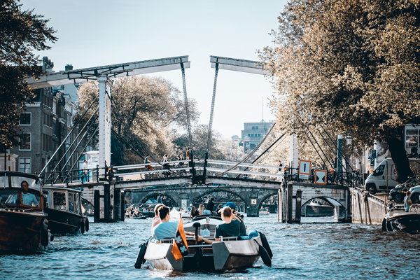 A view of an Amsterdam canal on a sunny day.